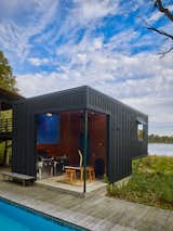 The cantilevered cabana keeps the structure low and maintains views of the pool from the house deck. The protected outdoor kitchen is great for entertaining, and the flat roof will ultimately feature a higher elevation deck.