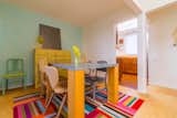 Sun drenched  dining room and kitchen, cork floors and vintage mismatched chairs 