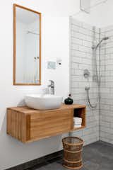 Bath Room, Wood Counter, Ceiling Lighting, Vessel Sink, Ceramic Tile Floor, Pendant Lighting, One Piece Toilet, Ceramic Tile Wall, and Open Shower eco design apartment by fine interior I bath  Photo 4 of 10 in eco design apartment by fine interior / Kirsten Wiegand