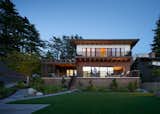 Composite fiber cement panels on top imitate Japanese tatami mat proportions. The lower two levels feature two types of shou sugi ban cedar siding and charred cedar rails.