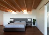 The master bedroom includes built-in night stands and a barn style door to the en suite bathroom.