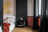 This is a supporting concrete wall. Yes she is painted black. And this is not a wooden panel, but a wallpaper with a picture