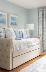 Sky blue walls, accent pillows and artwork were selected to coordinate with a unique bed design within another guest retreat.