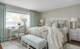 The master bedroom pulled an aqua hue into accessories, upholstery and draperies to coordinate with neutral furnishings and unique lighting.