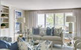 Neutral upholstered deep seating in the living room, accented with decorative pillows and occasional seating, continued the classic blue presentation.