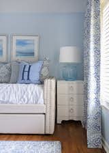 Sky blue walls, accent pillows and artwork were selected to coordinate with a unique bed design within another guest retreat.