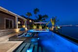 Under the stars, this elegant outdoor living area offers a dramatic wow in an economy of space. A swimming pool, spa and sunken fire lounge highlight the space, Outdoor LED lighting adds interest to the waters and plantings