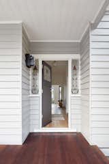 The original front door with a new entry hallway is inserted between two existing bedrooms, which were retained.