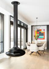 Dining Room, Chair, Medium Hardwood Floor, Table, Pendant Lighting, and Hanging Fireplace  Photo 13 of 14 in Sugarcubes by Alloy Homes Incorporated