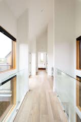 Hallway and Light Hardwood Floor  Photo 12 of 14 in Modern Farmhouse by Alloy Homes Incorporated