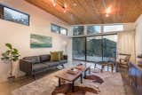 Living Room, Track Lighting, Sofa, Console Tables, Chair, Lamps, Coffee Tables, Ceiling Lighting, and Concrete Floor Living Space  Photo 3 of 11 in Modern Hillside by Edward B. Sawyer by Brittainy Williamson