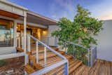 Outdoor, Wire Fences, Wall, Landscape Lighting, Metal Fences, Wall, Decking Patio, Porch, Deck, Front Yard, Wood Patio, Porch, Deck, Large Patio, Porch, Deck, Hanging Lighting, and Horizontal Fences, Wall Front Entry  Photo 4 of 11 in Modern Hillside by Edward B. Sawyer by Brittainy Williamson