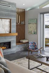 K-2 Quarry Stone Linear Fireplace, Inside Weather Modern Chair. Ketra tray ceiling light tuned to the perfect hue to enhance the shoreline and art. Artist Alison Engle