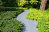 A meandering crushed stone path leads you to the rear yard.