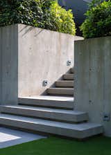 A play of light and shadow cast on architectural concrete features.