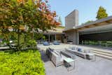 A year-round entertainment terrace fitted with an outdoor firepit, kitchen and loungers.