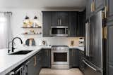 You would never know that these were the existing cabinets that we had professionally painted. The steel shelves modernizes the space and this view never gets old.
