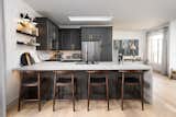 The classic feel of the cabinetry mixed with the Scandinavian stools and vertical paneling is so unique.