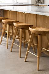 Minimal Scandinavian with Desert Influence - oak wood stools, brass foot rest, polished concrete floors