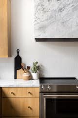Minimal Scandinavian with Desert Influence - oak cabinets, marble countertops, white herringbone tile