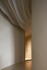 the corridor leads customers to naturally follow a curved flow
