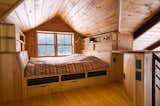 Bedroom, Medium Hardwood Floor, Bed, Bunks, Wall Lighting, Storage, Shelves, Night Stands, and Bookcase  Photo 7 of 14 in Vermont Organic Farmstead by Birdseye