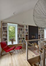 Living Room, Storage, Bookcase, Accent Lighting, Chair, Light Hardwood Floor, Ottomans, Standard Layout Fireplace, Ceiling Lighting, Shelves, Wood Burning Fireplace, and Wall Lighting ©Peter Murdock  Photo 14 of 19 in Battenkill by Birdseye