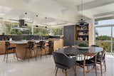 Custom walnut kitchen with Saarinen dining table and Louis Poulsen lighting