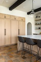 The hidden coffee bar is open for morning routines, but closed off later for a clean look.