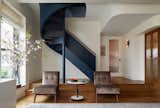 The completely remade spiral stair leads to two bedrooms and a bath upstairs. The pocket door at right leads to a small third bedroom with bunk beds.