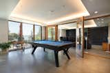 To encourage gathering, Rhodes Architecture worked closely with the owner to create special family places such as a music bar and jam space with storage for instruments, refreshments, even a “Marshall Amp” refrigerator. The lowest level is dedicated to play incorporating home gaming and theater, billiards, music, family discussions + hangouts with direct access to the western terraces, gardens, and a park beyond. 