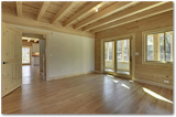 Bedroom, Ceiling Lighting, and Light Hardwood Floor Even the overhead beams are part of the solar heat storage mechanism. Massive Southern Pine beams form pockets for the warm air, which also heats the floor above. Pine, pine, pine - even the handmade pine door.  Photo 13 of 20 in Equinox 2, Extreme version on Christmas Lake by Enertia Building Systems Inc.