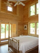 Guest Bedroom opens onto the sunspace, Tall ceilings, blond wood, many windows No lighting needed in the day. 