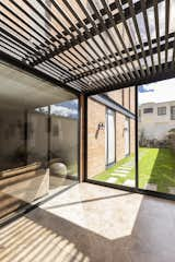 Living Room, Chair, Sofa, Ceiling Lighting, and Porcelain Tile Floor  Photo 10 of 16 in The Mera House by Pablo Cisneros R.