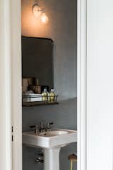 A view into one of the cloakrooms with a frameless door and vintage styling. 