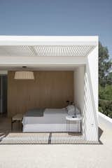 Bedroom, Ceiling Lighting, Wardrobe, Bench, Travertine Floor, and Bed  Photo 20 of 21 in Casa en Dorrego by  Architect Jorge Muradas