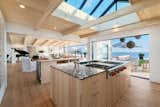 The chef’s kitchen has a custom skylight, a 6-burner Wolf range, and double ovens.