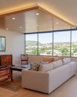 Living Room, Accent Lighting, Ceiling Lighting, and Light Hardwood Floor Iconic views of Diamond Head, surrounding neighborhood, malls & shops  Photo 2 of 17 in Scott Residence by District Architecture + Design