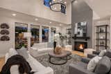 Double height family room with grey brick fireplace