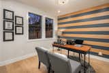 Den Accent Wall with alternating wood and blue stripes