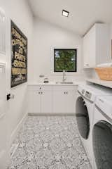 Vaulted laundry room with patterned floors