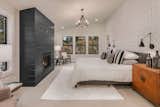Master Bedroom with Geometric Wallpaper and black shiplap fireplace