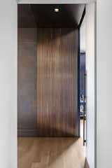 Entry corrugated bronze panel adjacent glass door