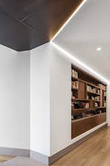 Second apartment entry bookshelf, concrete floor, and metal ceiling with light detail