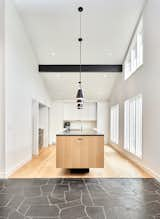 Kitchen, Refrigerator, Light Hardwood Floor, Wood Cabinet, Pendant Lighting, and Granite Counter The latest long view  Photo 1 of 10 in R&D Residence by mark hurley