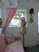 A peaceful retreat, this pink oasis features classic details, from the floral pillows to the cuckoo clock. 