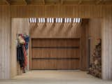 The large barn slider closed in the Outdoor Room, with the timber-battened clear roofing filtering light through from above.