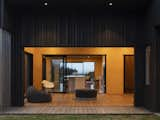 Living Room, Painted Wood Floor, Bench, Ottomans, Light Hardwood Floor, Chair, Plywood Floor, Sofa, Medium Hardwood Floor, and Stools Ambiguous and free flowing, the Outdoor Room is designed in the interstices of indoor and outdoor   Photo 1 of 8 in The Crest House by MAKE Architects 