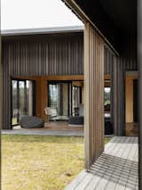 The surrounding land is cloaked with local Kanuka trees, a dark bark of the Mangawhai Peninsula, mimicked by the exterior dark stained ply cladding and cedar timber slatting rhythmically sequenced – as if the house is the architectural imagination of the surrounding forest’s collective heartbeat.  