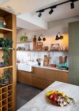 Kitchen, Marble Counter, Dishwasher, Concrete Floor, Marble Backsplashe, Vessel Sink, Wood Cabinet, Track Lighting, and Wall Lighting  Photo 7 of 10 in Virrey Apartment by Nicolas Mujica